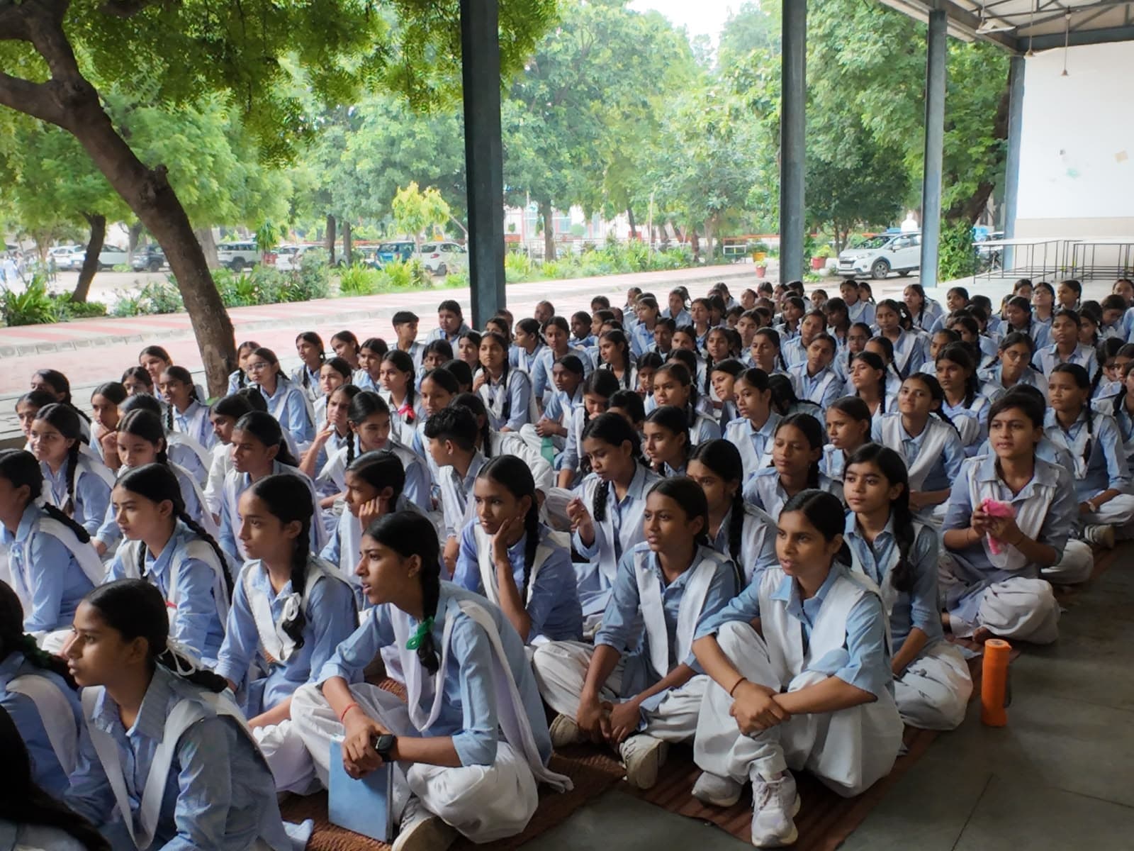 A hall of attentive schoolgirls during an EmpowerHer menstrual health awareness session